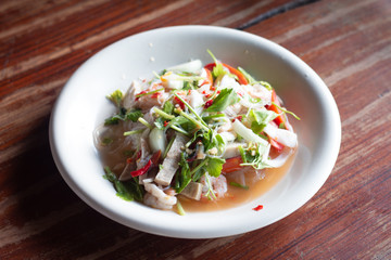 Pork sausage spicy salad on wooden table