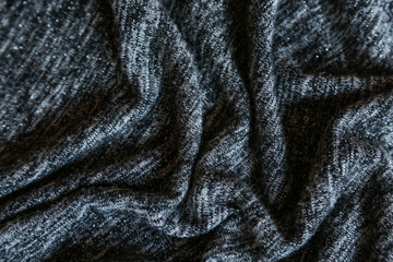  Grey cotton fabric background. Close up gray fabric texture background. wrinkled and shadows, selective focus top view