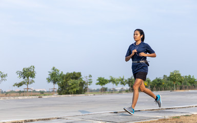 Asian woman running in the park ,Exercise concept, Lifestyle fitness and active women exercise in urban city concept.