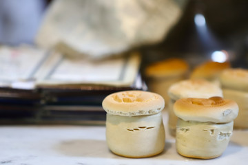 The liturgical liturgical bread of Prosphorus, Prosphora used during Orthodox worship. Preparation for Holy Communion. hands of the priest, icons placed on the altar of the Orthodox Church. The concep