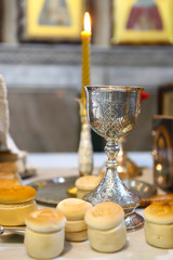 The liturgical liturgical bread of Prosphorus, Prosphora used during Orthodox worship. Preparation for Holy Communion. hands of the priest, icons placed on the altar of the Orthodox Church. The concep