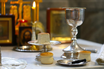 The liturgical liturgical bread of Prosphorus, Prosphora used during Orthodox worship. Preparation for Holy Communion. hands of the priest, icons placed on the altar of the Orthodox Church. The concep