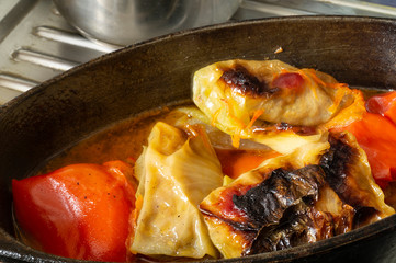 Stuffed cabbage and red pepper in sauce