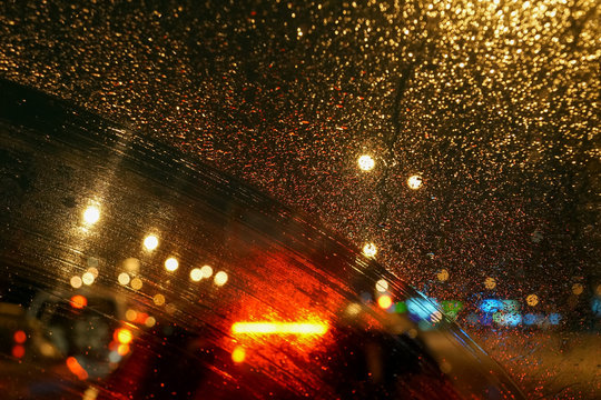 raindrops and a trace of the windshield wiper on the car © Elena