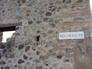 A stone penis on the wall of a building in Pompeii, Italy pointing the way to the brothel 