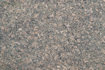 Black granite with pale red spots. Granite slab with pink and beige light crystals of stone. Textured Background. Mica, feldspar, and quartz are visible in the section.
