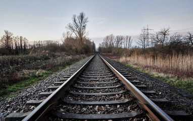 Fototapeta na wymiar Train track in countryside landscape leading into distance