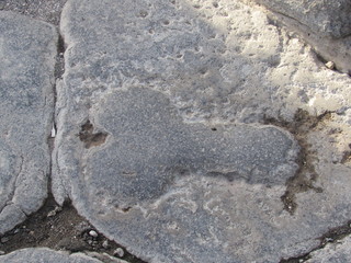 Phallic shaped carving on the road in Pompeii, Italy pointing the way to the brothel 