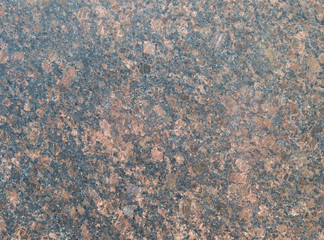 Black granite with pale red spots. Granite slab with pink and beige light crystals of stone. Textured Background. Mica, feldspar, and quartz are visible in the section.