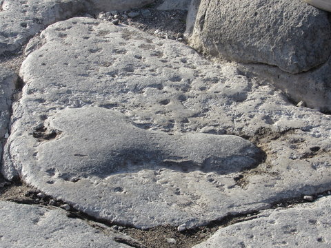 Phallic shaped carving on the road in Pompeii, Italy pointing the way to the brothel 