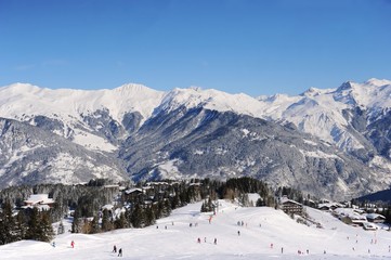 Fototapeta na wymiar Ski resort Courchevel in winter with snowy mountains and ski slopes 
