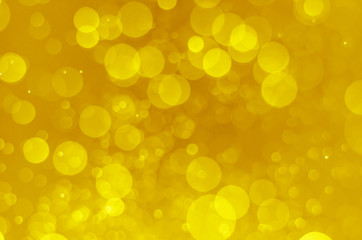 abstract yellow bokeh glitter sparkle background.
