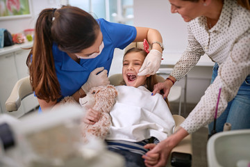 Girl with open mouth at dentist