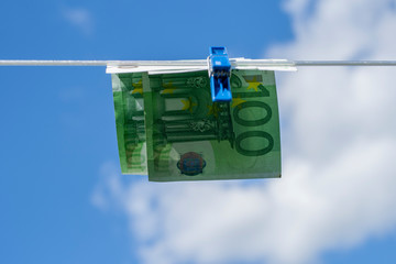 Fototapeta na wymiar 100 euro banknotes on a clothesline