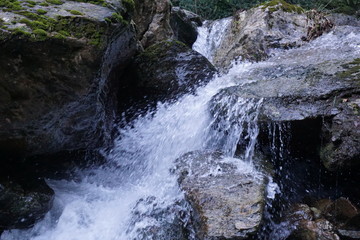 Water flows into a mountain river