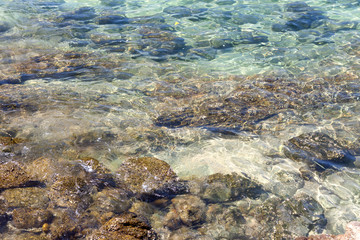 Clear, clear seawater covering the stones.