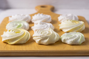 Obraz na płótnie Canvas Homemade sweet colored meringue on white background. .Dessert.