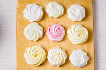 Homemade sweet colored meringue on wooden background.  .Dessert. Top view.
