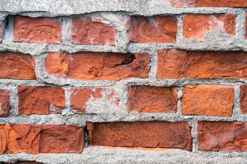 Obraz premium Weathered and old rustic brick wall closeup covered with destroyed concrete surface. Creative, backdrop and wallpaper concept.
