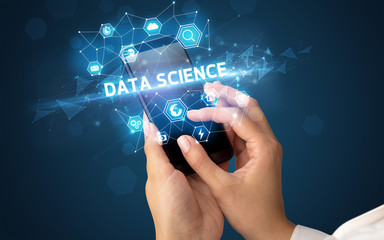 Female hand holding smartphone with DATA SCIENCE inscription, modern technology concept