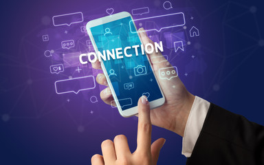 Female hand typing on smartphone with CONNECTION inscription, social media concept