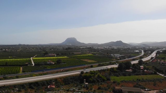 Aerial view of the AP7 highway in the cities of Ondara and Denia, Spain. Montgo mountain is in the background.