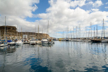 Fototapeta na wymiar Puerto de Mogan port view with boats, yachts and sailboats, Gran Canaria, Canary Islands, Spain