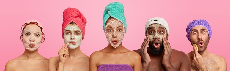 Shocked women and men of different races wear applied face masks, have beauty treatments after...
