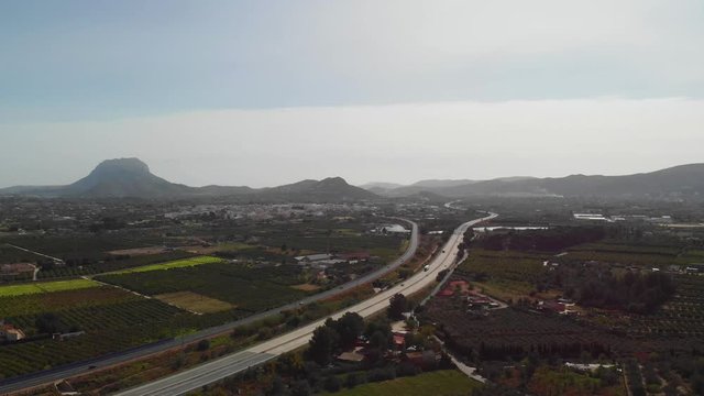 Aerial view of the AP7 highway in the cities of Ondara and Denia, Spain. Montgo mountain is in the background.