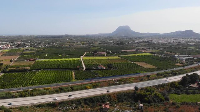 Aerial view of the AP7 highway in the cities of Ondara and Denia, Spain. Montgo mountain is in the background.