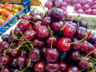 Fresh cherries are in a drawer in the store.