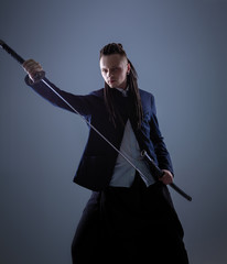 Young man holding a samurai sword. Glamour photo. © Andrii