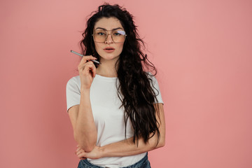 Fototapeta premium Portrait of a young girl on a pink background