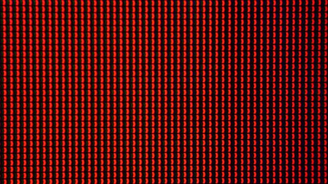 Macro shot of a computer display or TV screen. Multi-colored pixels as trace elements creating an image on an LED or LCD screen.