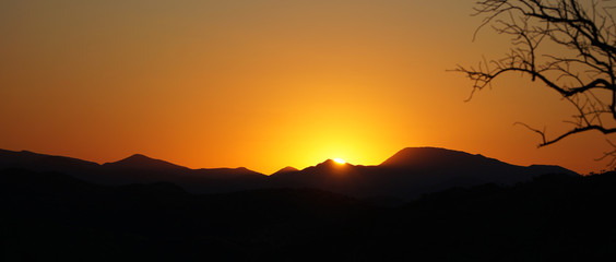 Sunset and orange sky near Epupa Falls waterfall in the Kaokoland of Namibia, Africa.