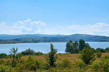 Fototapeta na wymiar Lake and its picturesque shores in summer