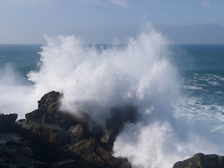Waves crashing on a pier in San Sebastian