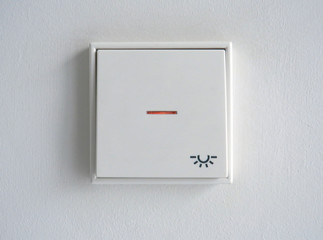 Light switch on white wall. Industrial and modern design. Architecture detail.