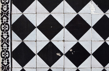 Fragment of a facade decorated with black and white tiles of azu