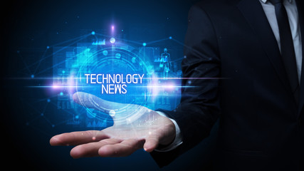 Man hand holding TECHNOLOGY NEWS inscription, technology concept