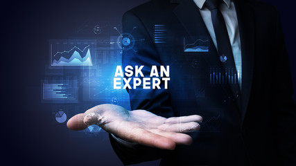 Hand of Businessman holding ASK AN EXPERT inscription, business success concept