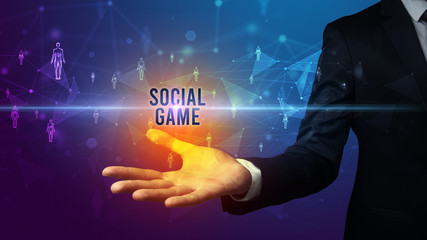 Elegant hand holding SOCIAL GAME inscription, social networking concept