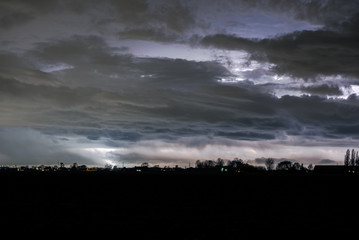 Dramatic clouds and lightning over the Netherlands at night