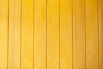 Old yellow wooden planks background close up