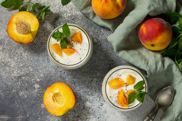 Natural detox, fruit dessert, healthy dieting concept. Peach Yogurt smoothie or milk shake with chia seeds in glass jar on a stone concrete worktop. Top view flat lay background.