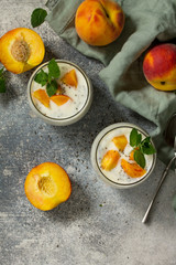 Natural detox, fruit dessert, healthy dieting concept. Peach Yogurt smoothie or milk shake with chia seeds in glass jar on a stone concrete worktop. Top view flat lay background. Copy space.