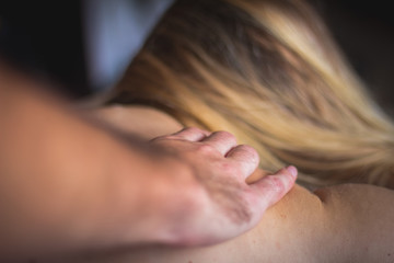 Woman at reflexotherapy massage made by man with hands