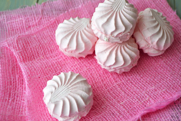 Zefir. Pink and white marshmallow zefir hand made. On pink napkin background.