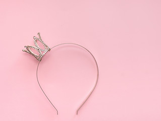 silver crown with sparkles on a girl for beauty on a pink background