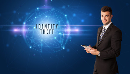 Businessman thinking about security solutions with IDENTITY THEFT inscription